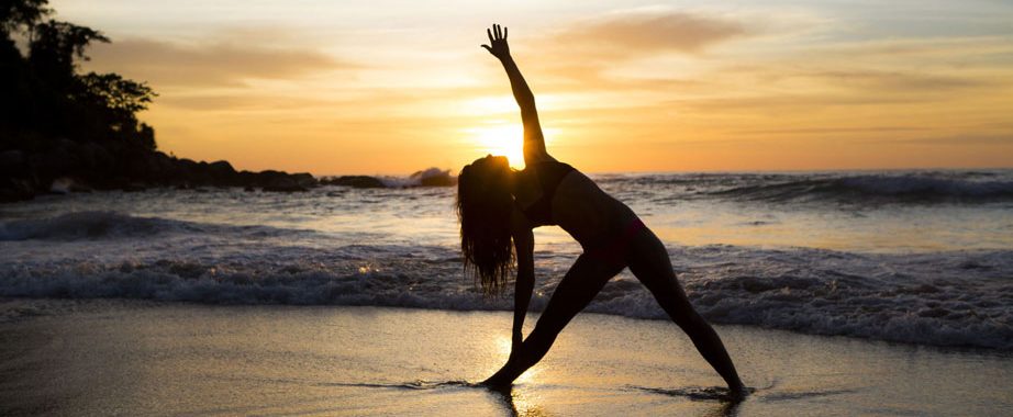 Yoga op het strand van Ibiza met zonsondergang